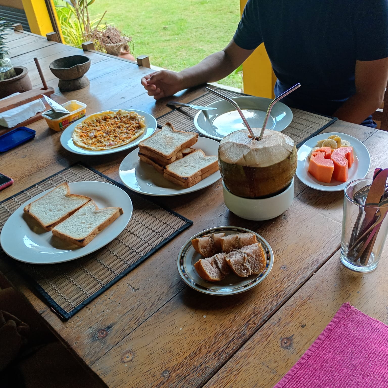 Breakfast at the table with a king coconut to drink