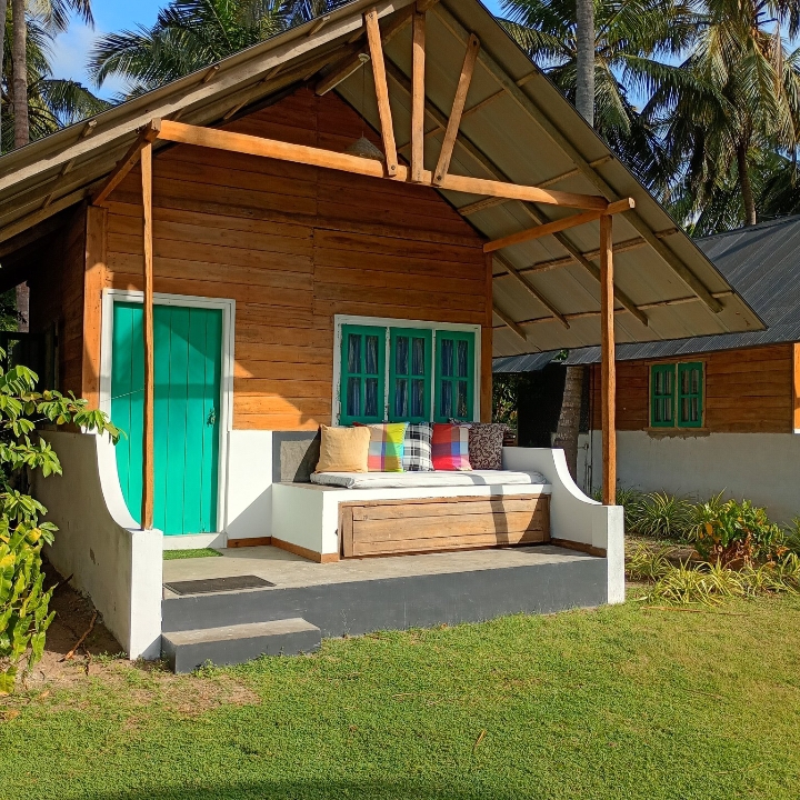 Timber cabana with teal doors on the verandah